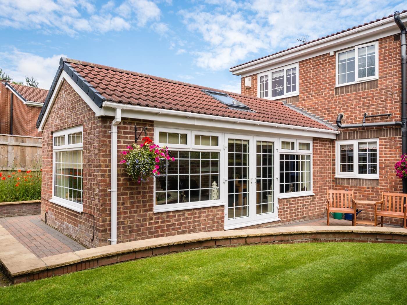 Modern rear extension with large glazing on a traditional British brick home